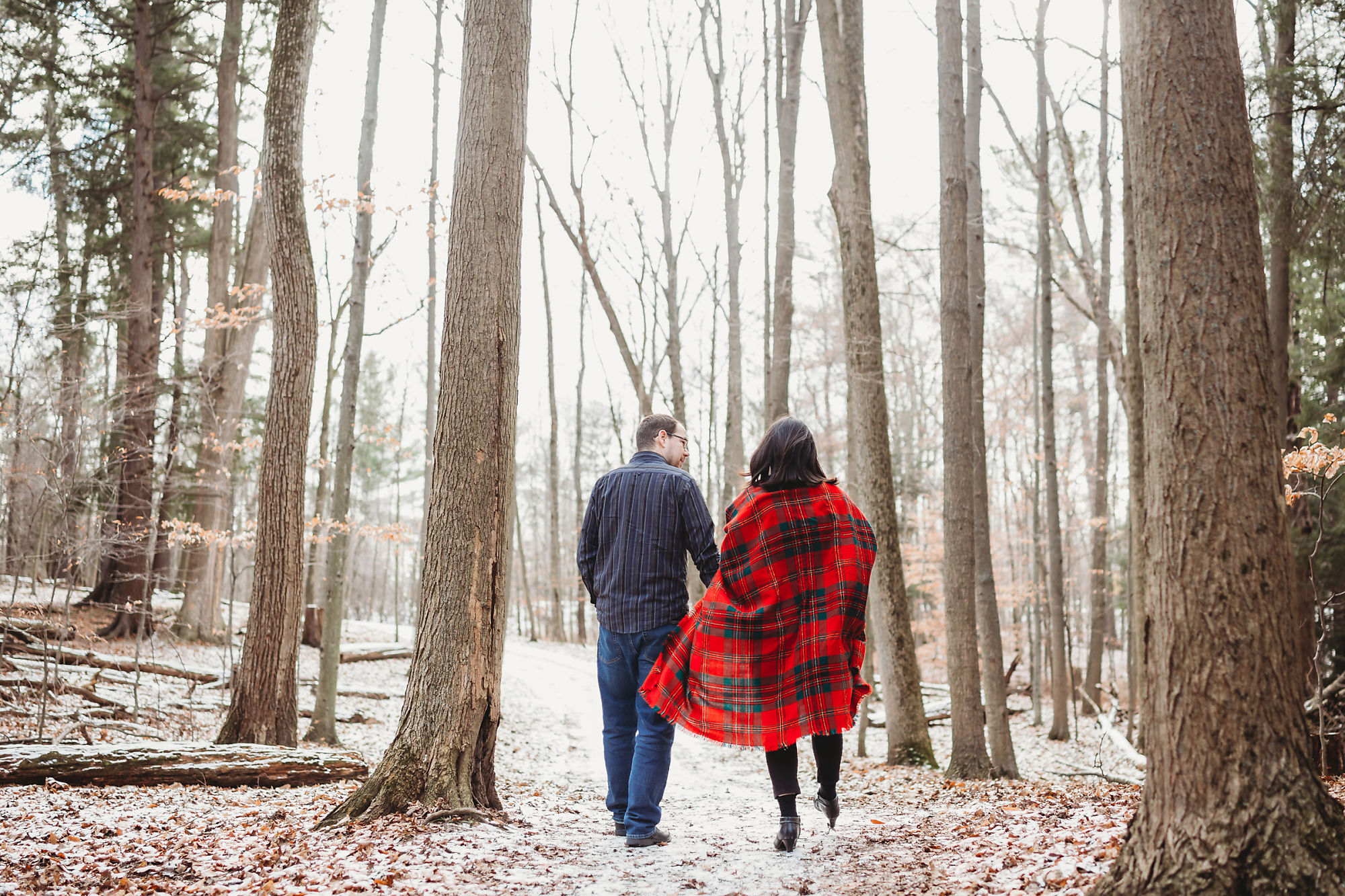 Andy & Erin walk through Dundas Conservation Area in Hamilton Ontario during their winter maternity photoshoot with Jennifer Blaak Photography.