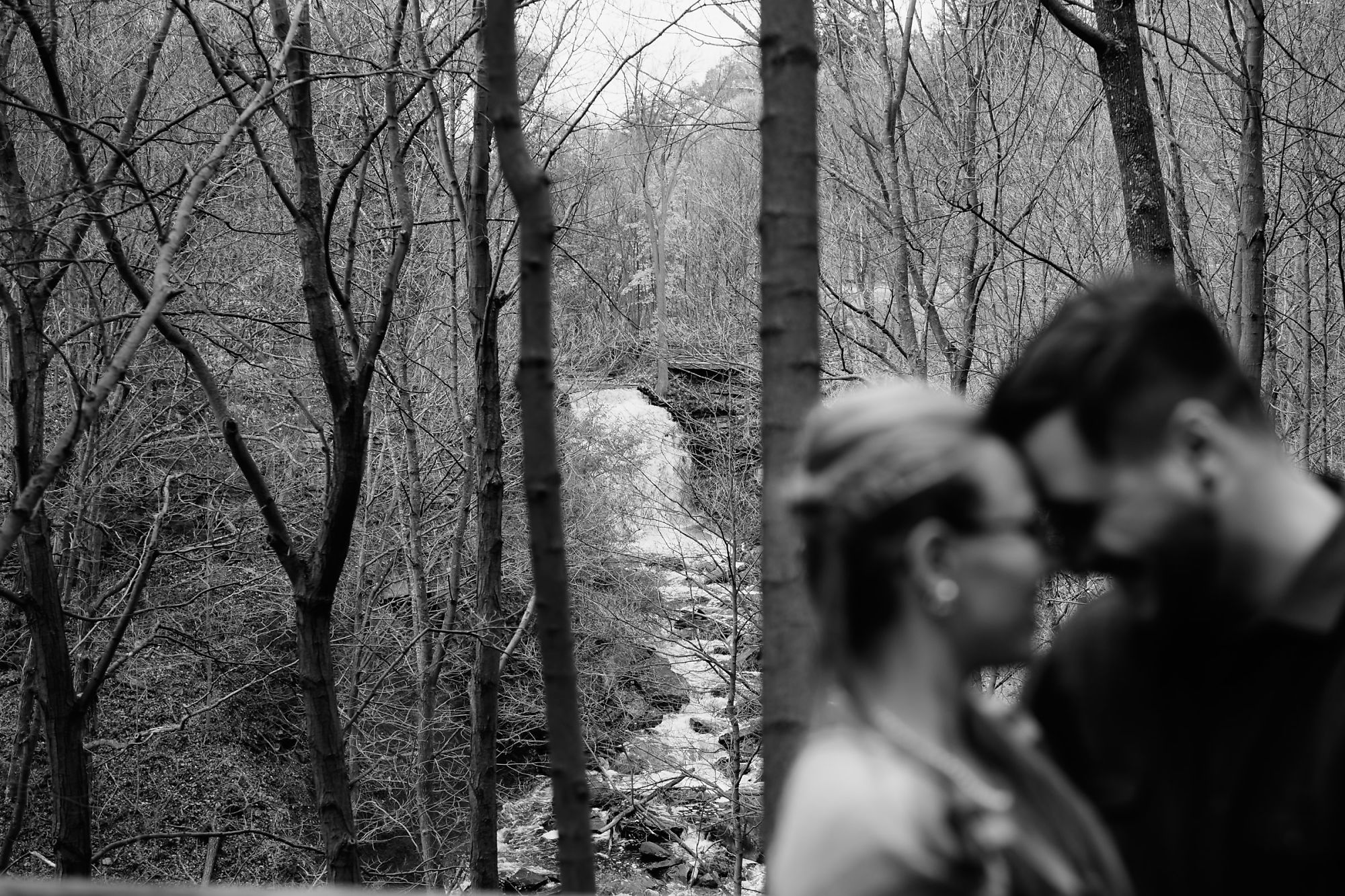 Artistic waterfall shot with couple Dan and Nina at Smokey Hollow Falls during their engagement session in Dundas Ontario with photographer Jennifer Blaak.