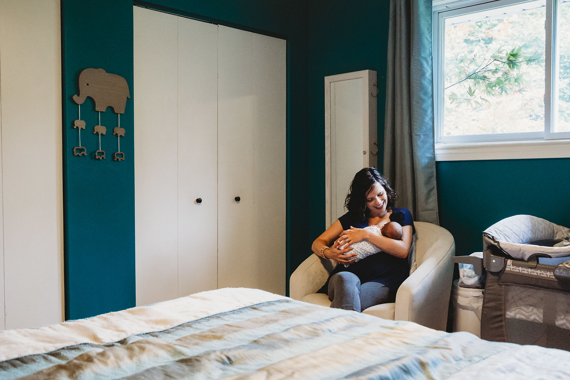 Documentary-style Dundas Newborn Photographer Jennifer Blaak captures mother and baby at home in their nursery in Hamilton. .