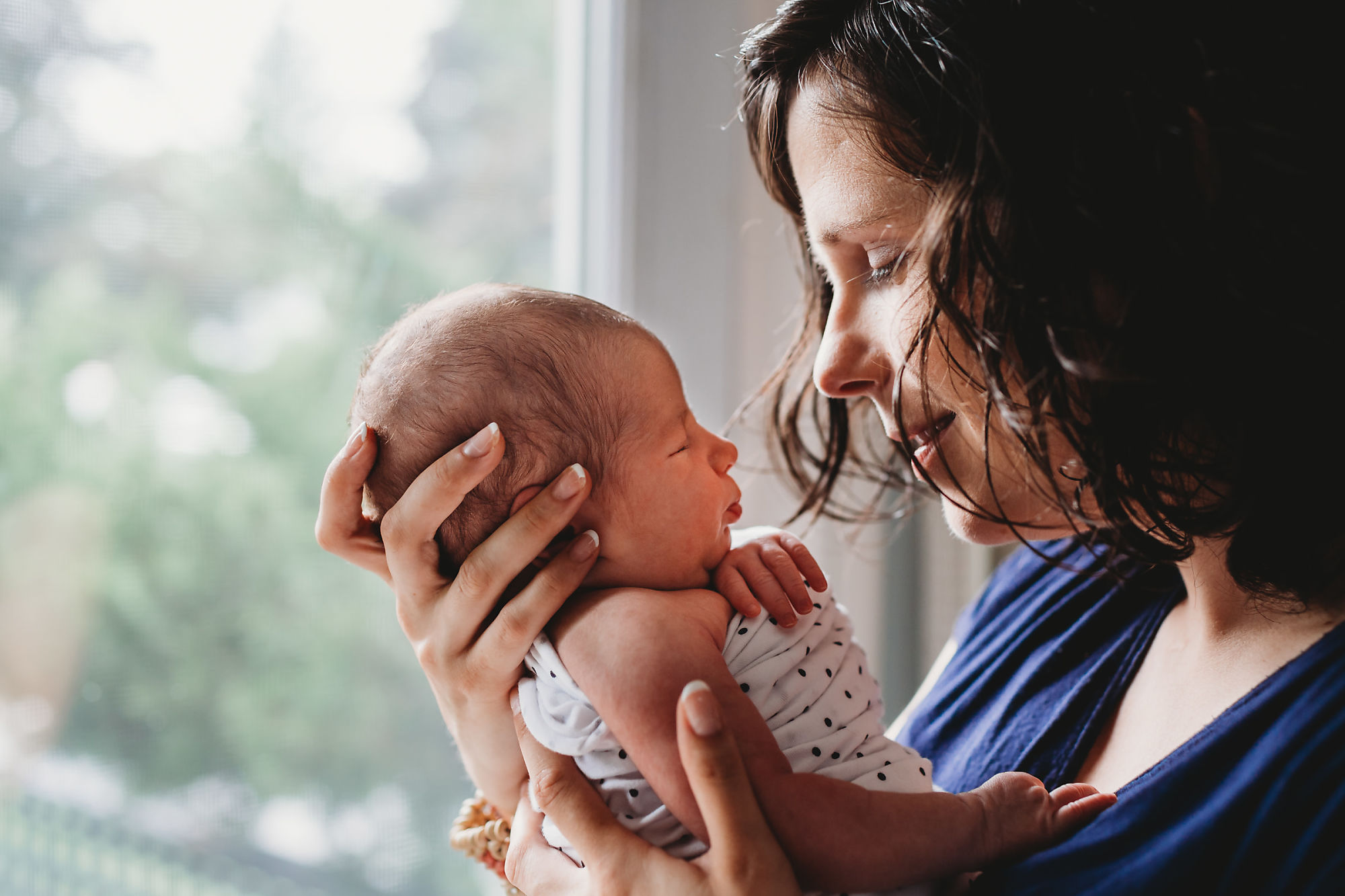 Dundas Newborn Photographer Jennifer Blaak captures a tender moment between mother and baby during their newborn and family lifestyle photography session at home in Hamilton.