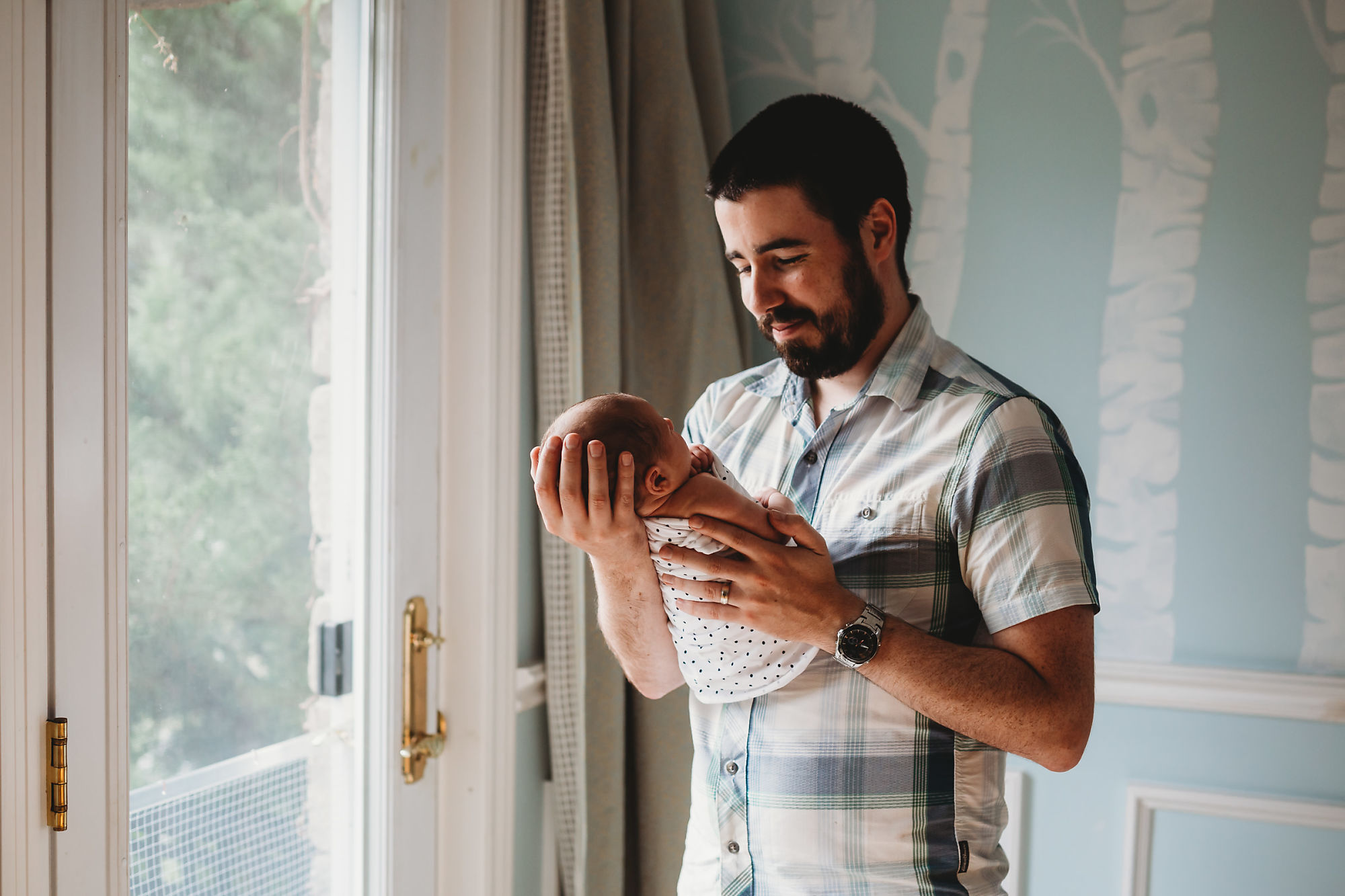 Dundas Newborn Photographer Jennifer Blaak captures the essence of fatherly love during their newborn and family lifestyle photography session at home in Hamilton.
