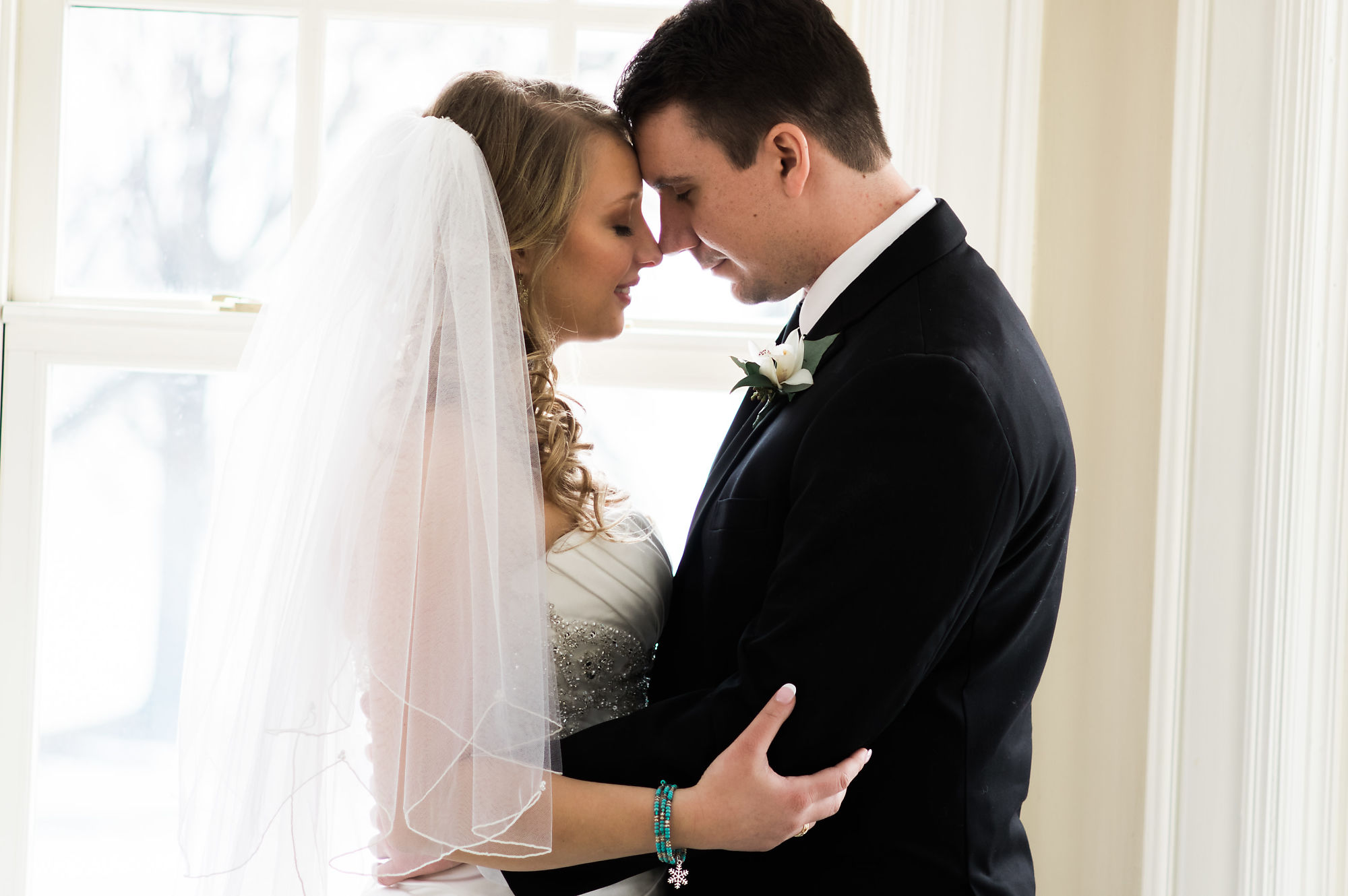 Newlywed's Kaitlyn and Nick embrace for portraits at Paletta Mansion during their wedding shoot with Burlington Wedding Photographer Jennifer Blaak.