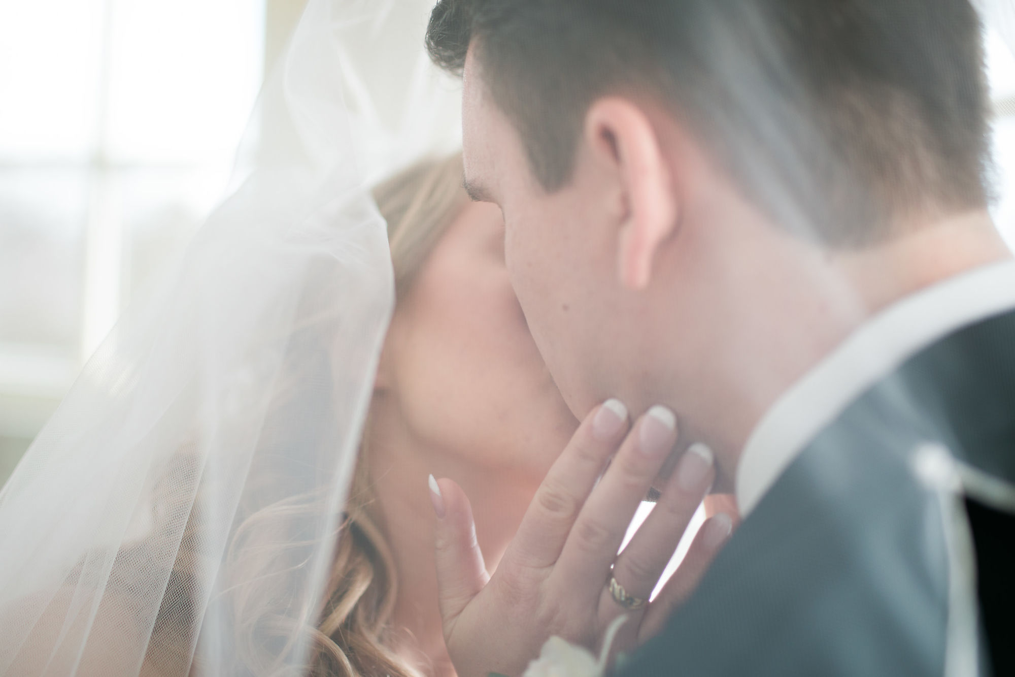 Newlywed's kiss under the veil at Paletta Mansion during their wedding shot with Burlington Wedding Photographer Jennifer Blaak.
