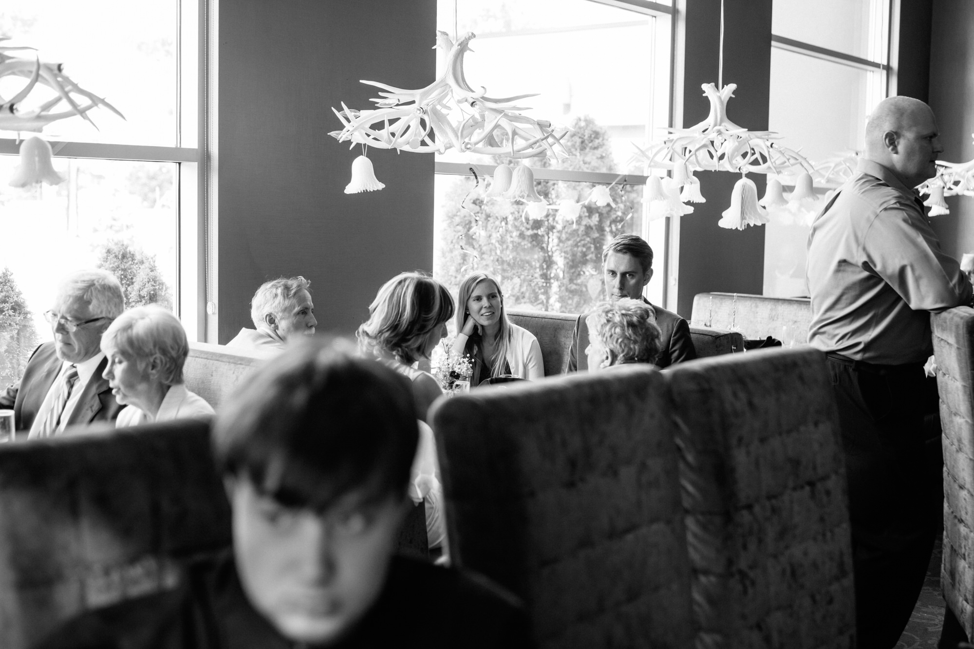 Black and white photo of CHOP steakhouse wedding reception guests. Mississauga wedding photographer Jennifer Blaak.