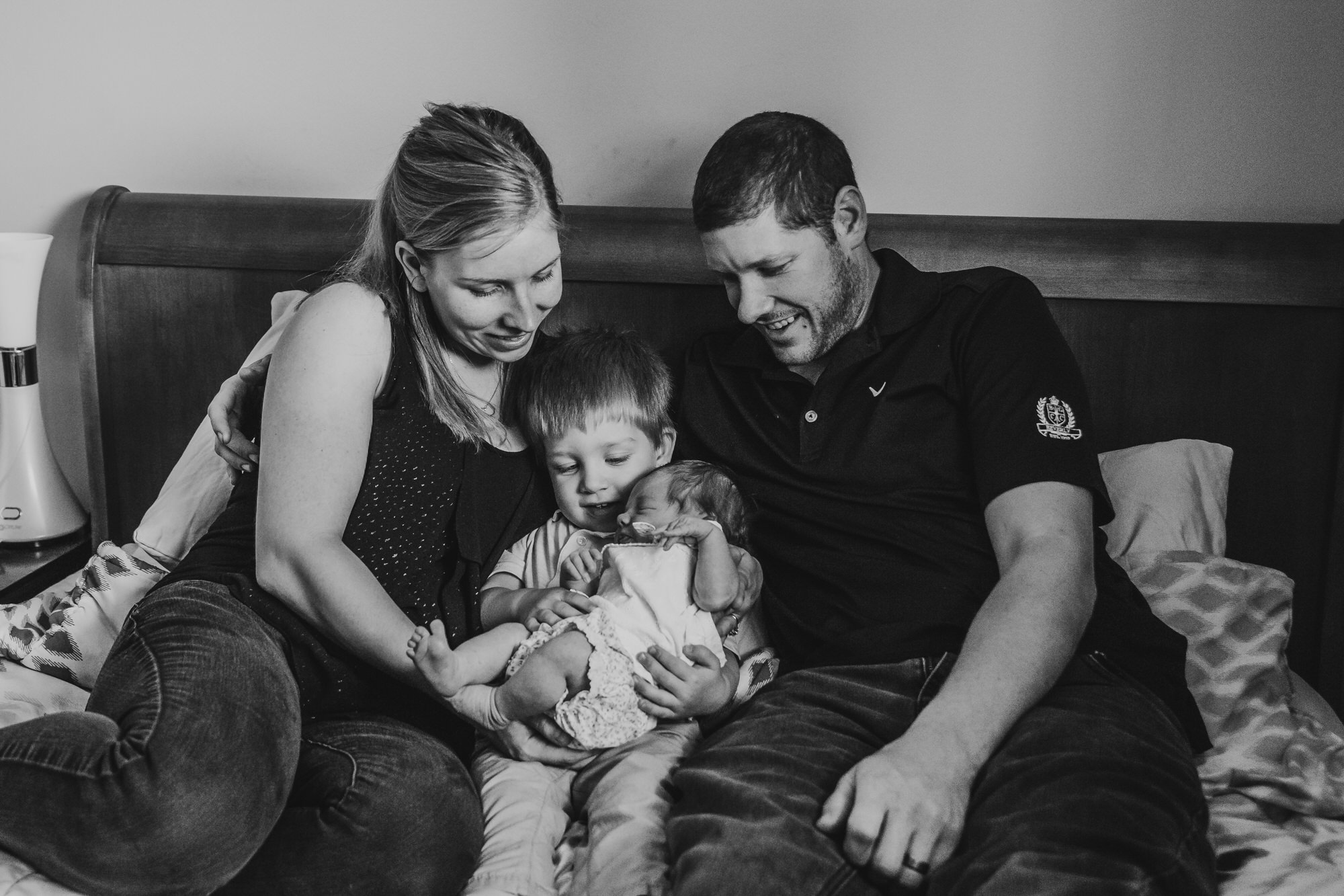 Dundas Newborn Photographer - family in the bed holding baby together