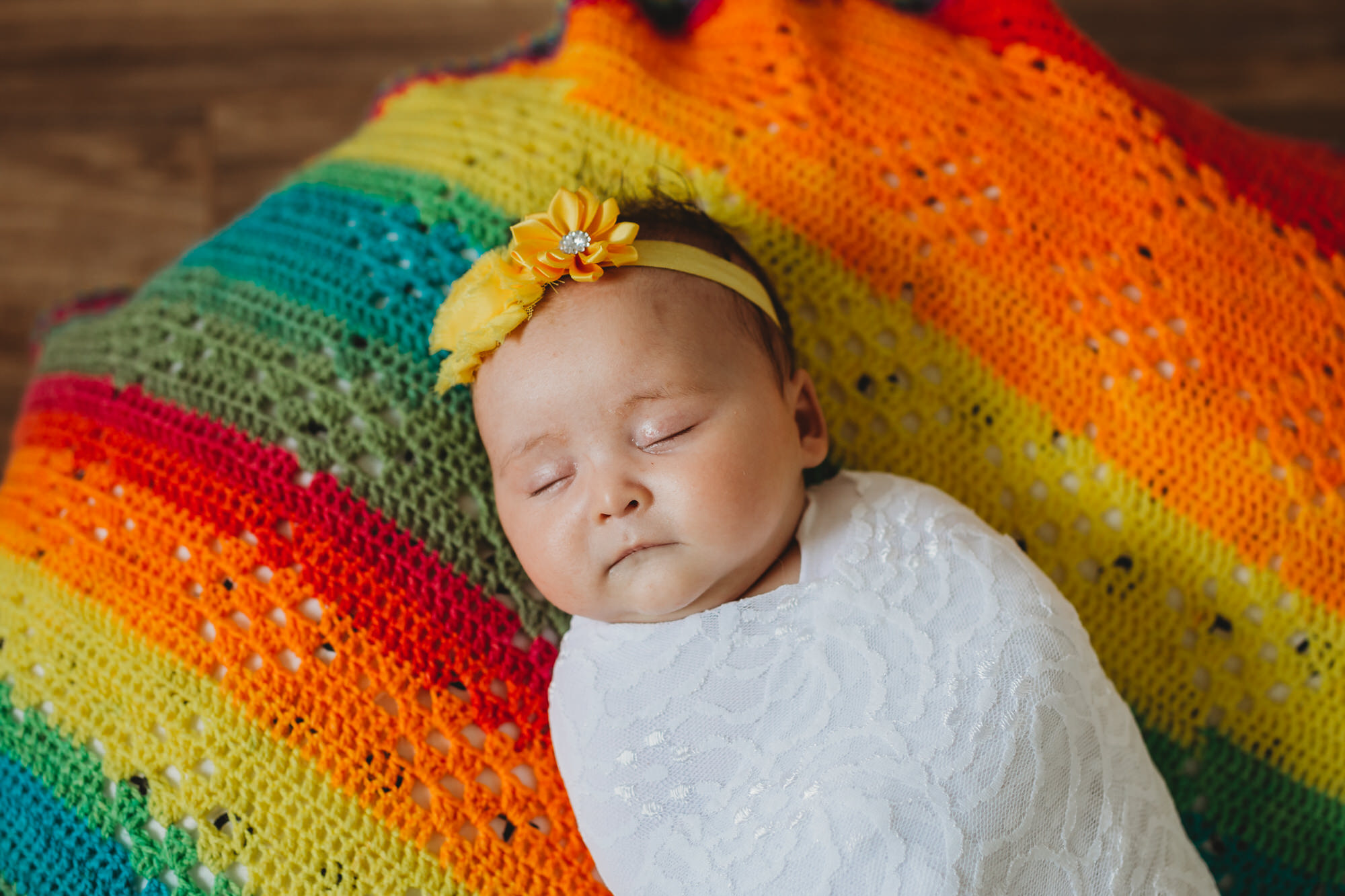 Cayuga Newborn Photographer - sleeping newborn rainbow blanket